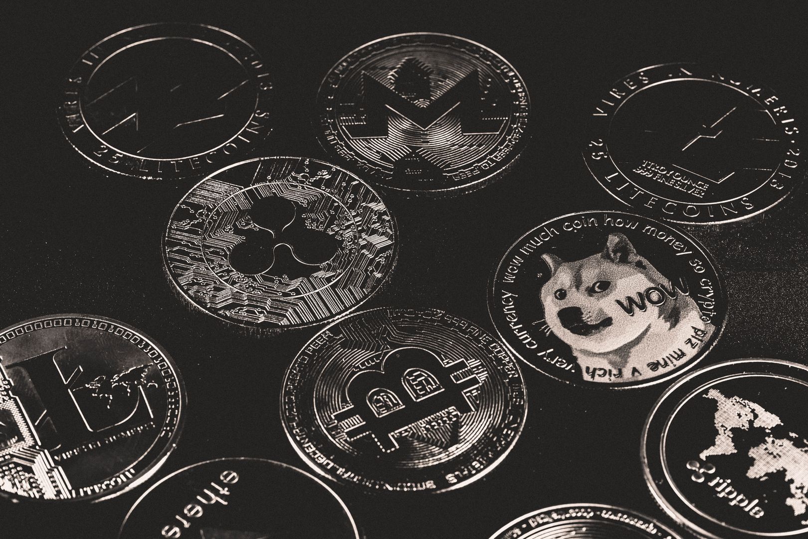A collection of various cryptocurrency coins including Bitcoin, Ethereum, and Dogecoin.